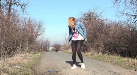 White girl Chrissy Fox pulls down black leggings to pee on a dirt road 85965720