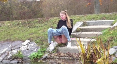 Claudia Macc descends concrete steps to take a piss into the water 21704823