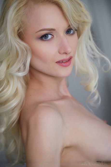 Young nude blonde Nika N demonstrating her tight shaved vagina
